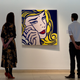 Gallery staff looking at Lichtenstein’s “Crying Girl” before a Christie’s sale in 2015. Image via Getty.